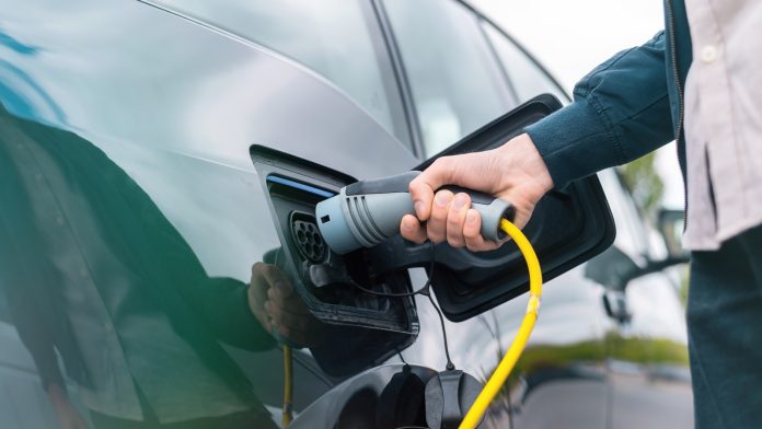 Man charging electric car