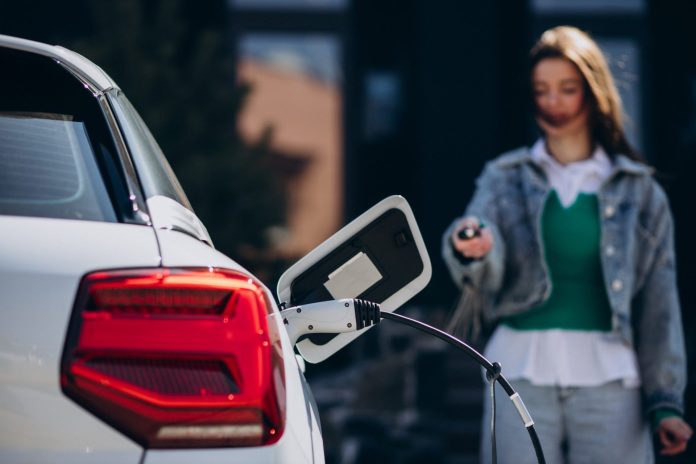 woman-charging-her-electric-car-with-charging-pistol
